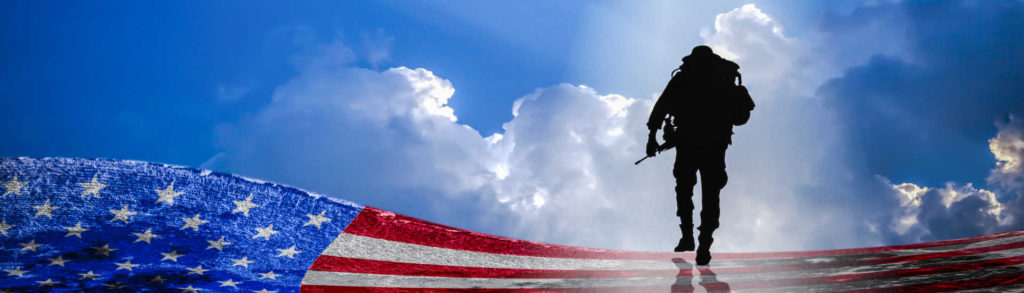Combat Veteran soldier with clouds and American Flag background